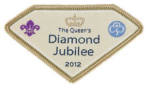 Gemstone-shaped badge in beige with Girlguiding and Scouting logos and a small crown in dark beige. Text: The Queen's Diamond Jubilee 2012