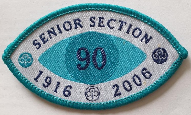 Eye-shaped Senior Section 90th Anniversary badge 1916-2016 in aqua and white colours