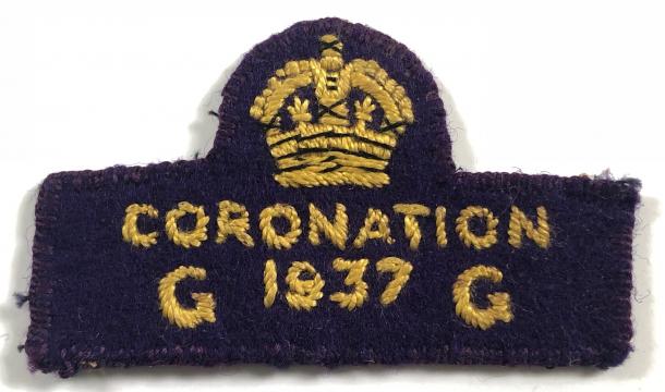 Dark blue felt badge featuring a gold crown and gold text: Coronation 1937 GG
