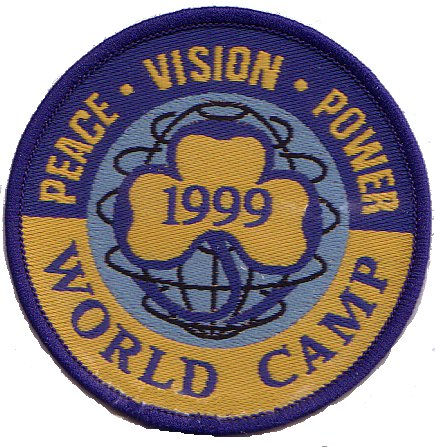 1999 World Camp Badge featuring yellow trefoil with 1999 upon a line drawing of a globe, with a surround lettered "Peace Vision Power World Camp".