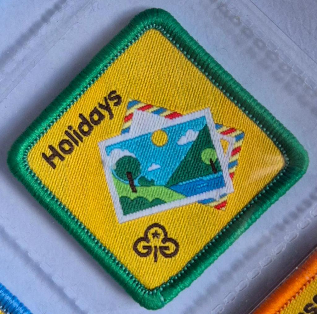 Brownie Holidays badge, green binding. Postcard and air mail envelope logo