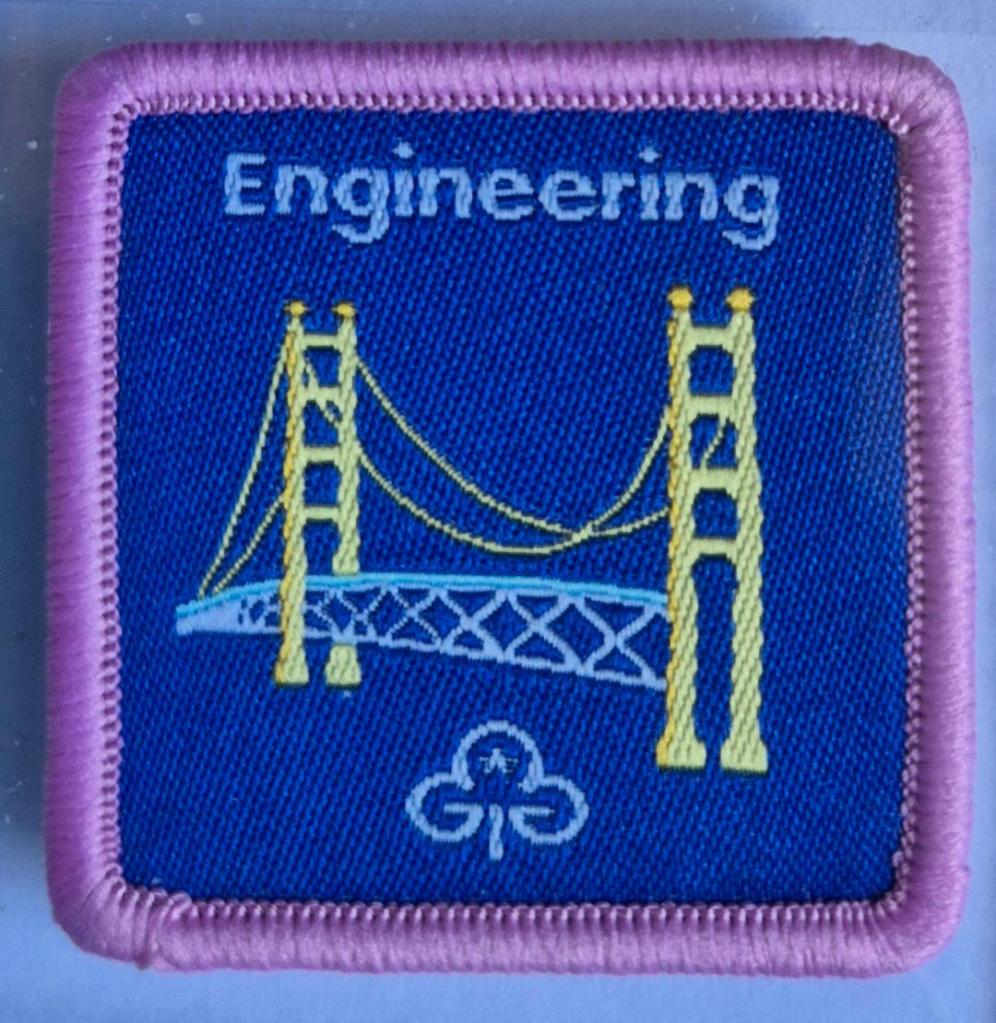 Guide Engineering badge, light pink binding.  Suspension bridge logo.