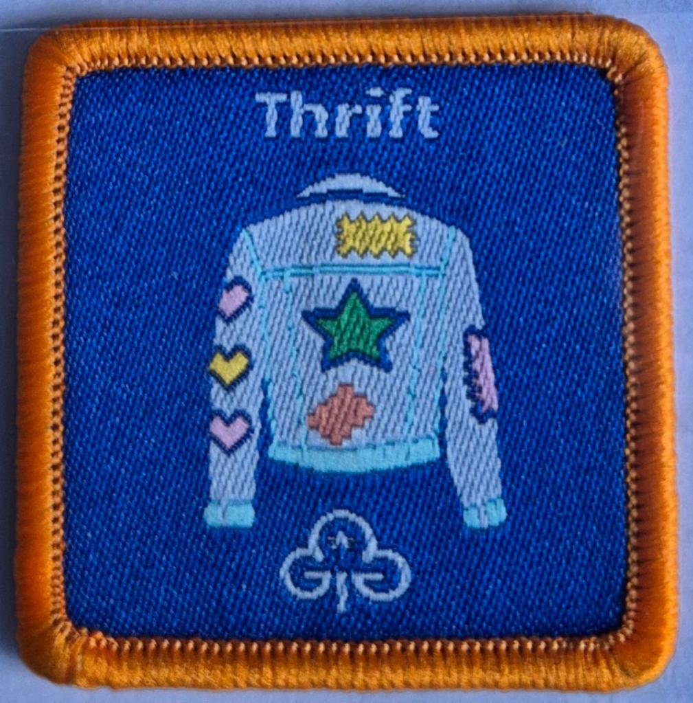 Guide Thrift badge, orange binding.  Denim jacket with patches logo.