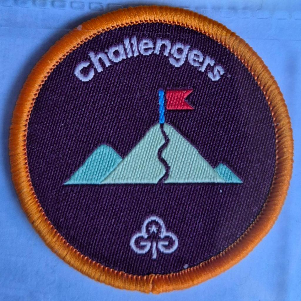 Ranger Challengers badge, orange binding.  Mountains with flag at summit logo.