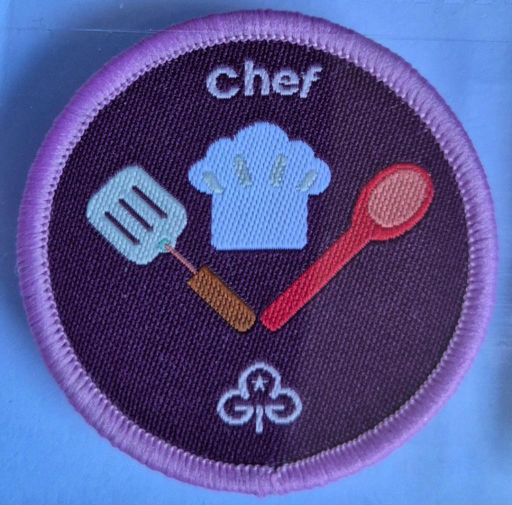 Ranger Chef badge, light pink binding.  Spatula, spoon and chef hat logo.