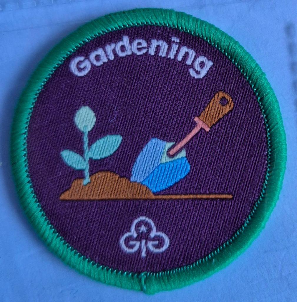 Ranger Gardening badge, green binding.  Trowel and seedling logo.